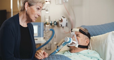 Patient using breathing device with ReddyPort elbow.