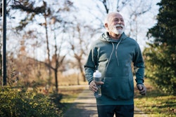 Photo of older man with beard jogging in a park