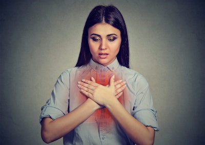 Picture of woman cross arms over reddened lungs.