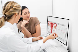 Doctor explaining reproductive issues to patient with image on computer screen.