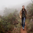 An attractive young woman out for a walk in the mountains.
