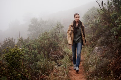 An attractive young woman out for a walk in the mountains.