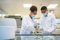 This picture is of two scientists working in a lab.