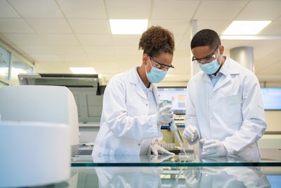 This picture is of two scientists working in a lab.