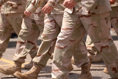 This photo shows the lower half of military people marching in uniform.