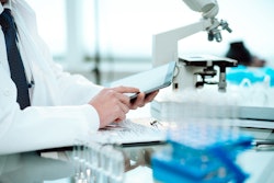 Scientist using a digital tablet in a science lab.