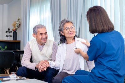 Senior couple get medical service visit from caregiver nurse at home.