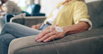 Healthcare, hands and senior woman with iv drip in a hospital for cancer, treatment or chemotherapy.