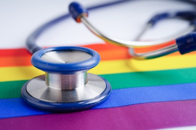 Image of a stethoscope on a rainbow flag.