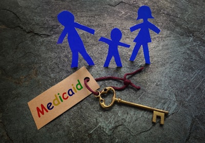 This picture shows a family of paper, stick figures next to a key labeled 'Medicaid.'