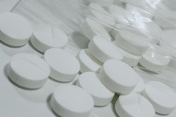This is a photo of white, metformin diabetes medicine laying on a lab counter.