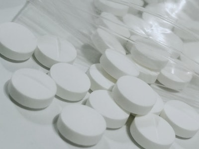 This is a photo of white, metformin diabetes medicine laying on a lab counter.