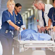This is a photo of a patient being rushed into a hospital by medical staff.