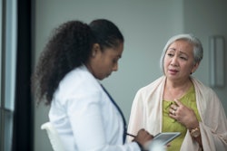 Female doctor diagnosing an older female patient.
