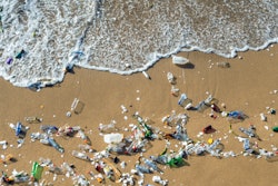 Waves pushing plastic waste to the beach