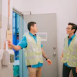 This is a photo of two Asian men clocking in at work.