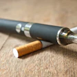 This is a photo of a vape pen and cigarette.
