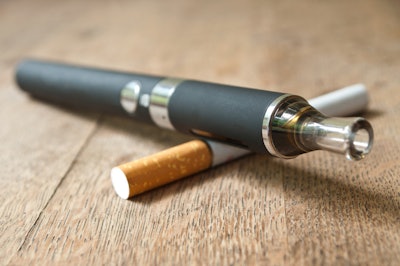 This is a photo of a vape pen and cigarette.