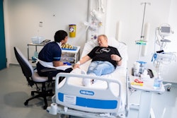 Senior research nurse Keenjee Nama with trial participant Janusz Racz