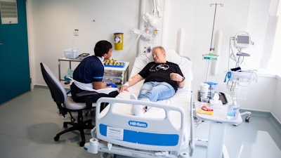Senior research nurse Keenjee Nama with trial participant Janusz Racz