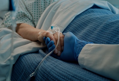 Hospital, holding hands and bed with doctor, support and care together