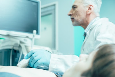 Close up of a doctor conducting ultrasound diagnostic of a man