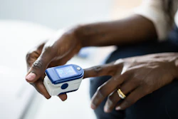 African American person using pulse oximeter