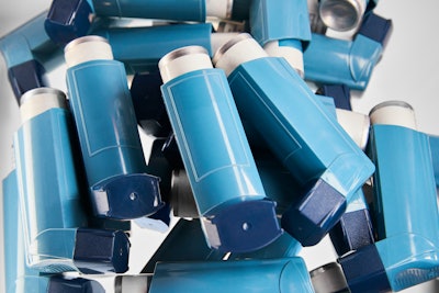 This is a photo of a pile of asthma inhalers.