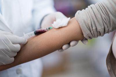 This is an image of a person getting a blood draw at a clinic.