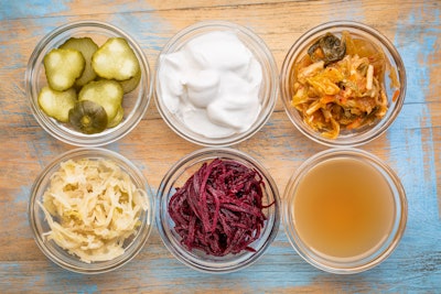 This is a photo of an array of fermented foods in jars, representing probiotics.