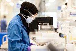 Scientist Inspecting Paperwork In Lab