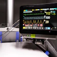 Medical vital signs monitor displaying heart rate and patient data in ICU