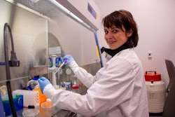 Claudia Loebel, MD, PhD, preparing samples in the lab.