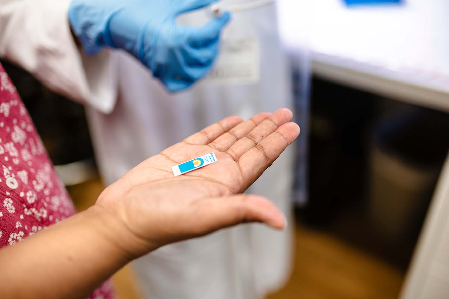 Shalini Prasad, PhD, holds a screen-printed electrochemical sensor.