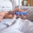 Person holding blue insulin pen for diabetes management injection