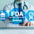 Healthcare professional displaying FDA approval badges on laptop screen with government building and quality assurance icons
