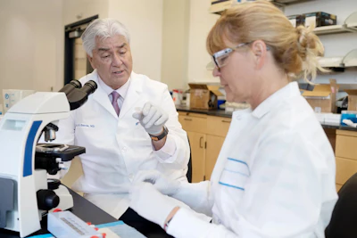 Joe G. N. Garcia, MD, associate vice president for research at UF Health, and Susannah Patarroyo-White, a senior staff scientist, work in the lab.