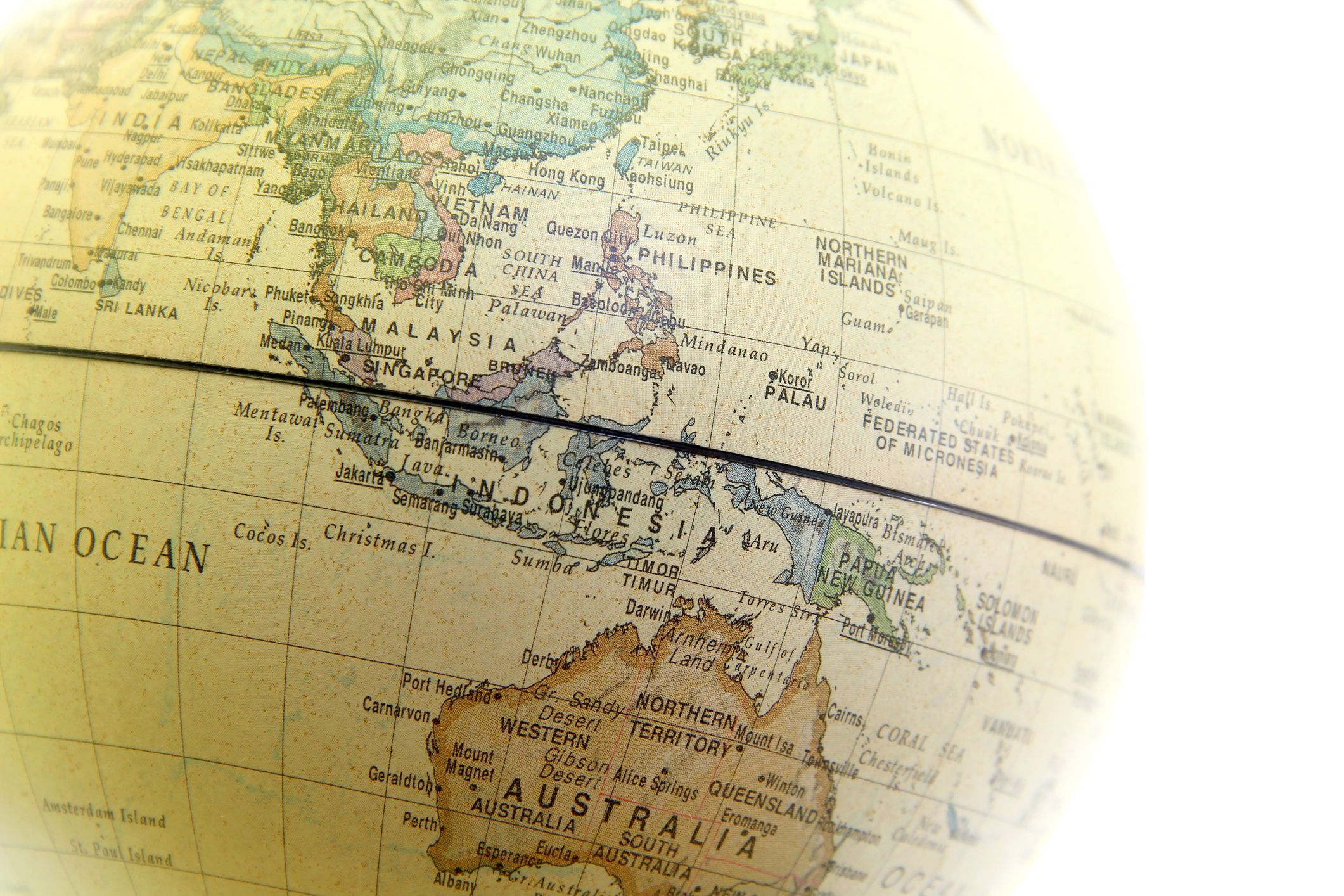 Vintage globe map showing Southeast Asia, Indonesia, Australia, and surrounding regions with geographical labels and a ruler overlay