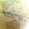 Vintage globe map showing Southeast Asia, Indonesia, Australia, and surrounding regions with geographical labels and a ruler overlay