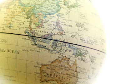 Vintage globe map showing Southeast Asia, Indonesia, Australia, and surrounding regions with geographical labels and a ruler overlay