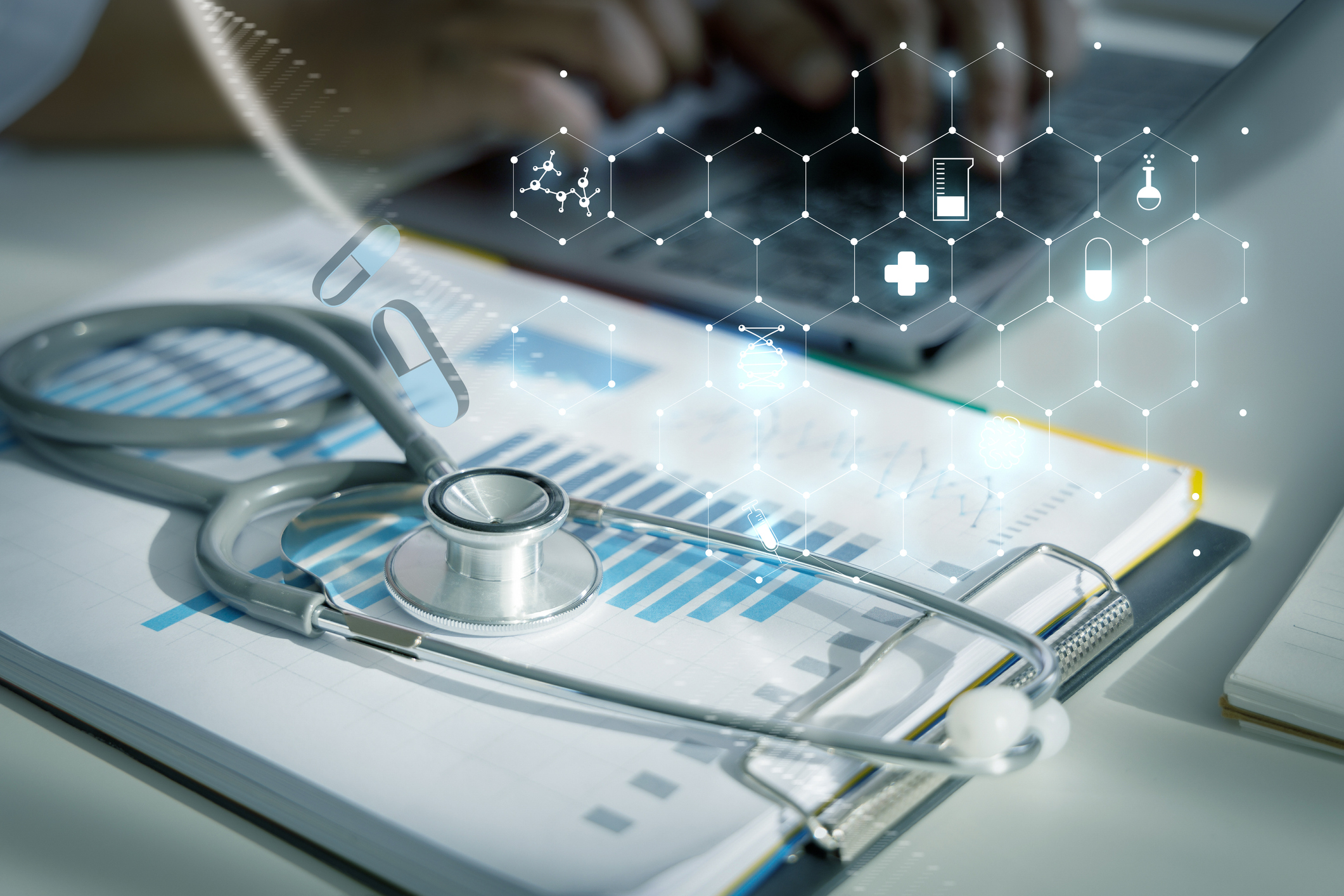 Healthcare professional workspace with stethoscope, medical charts, smartphone, and digital health technology icons